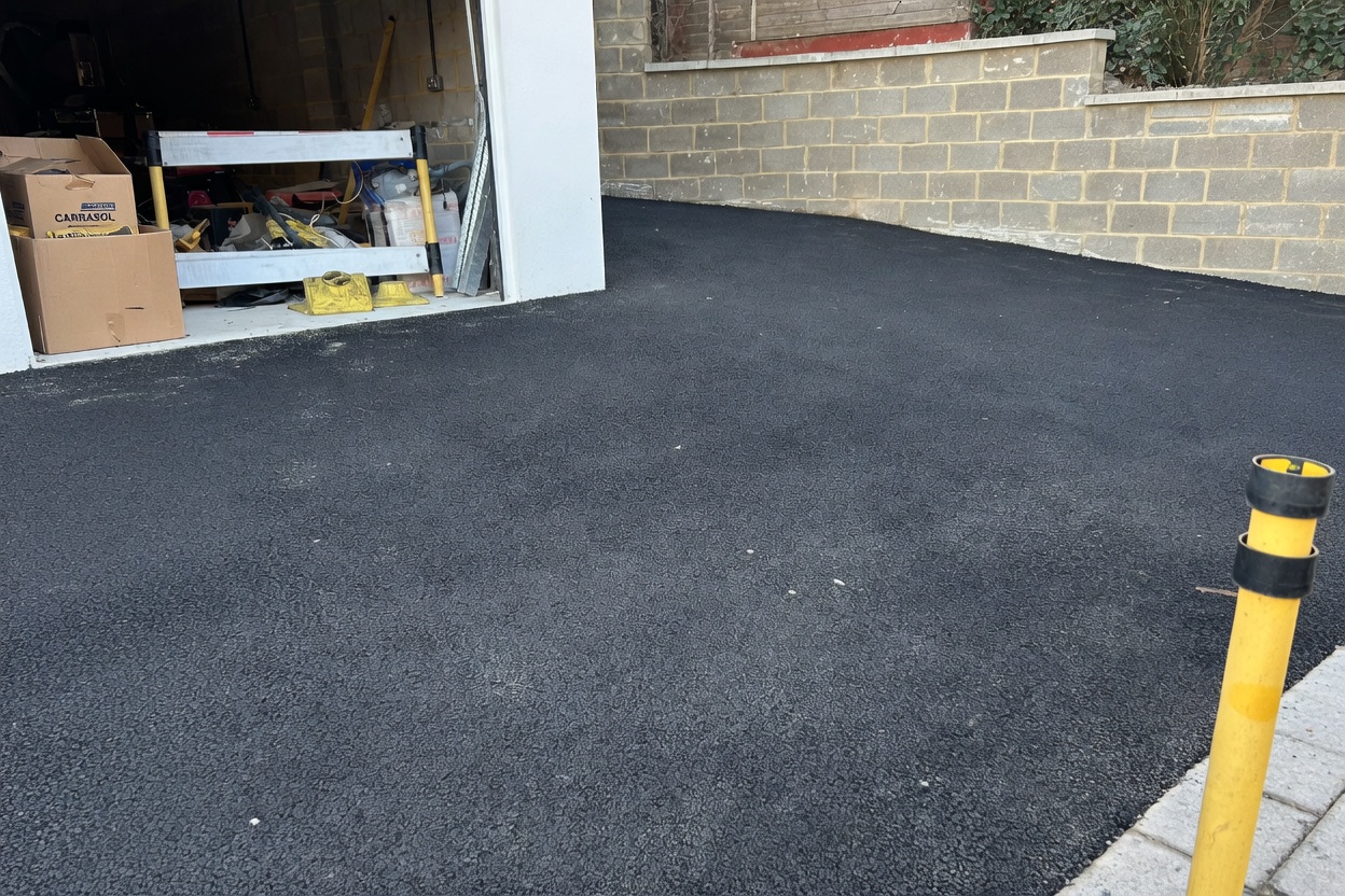 Finished tarmac driveway leading into the garage