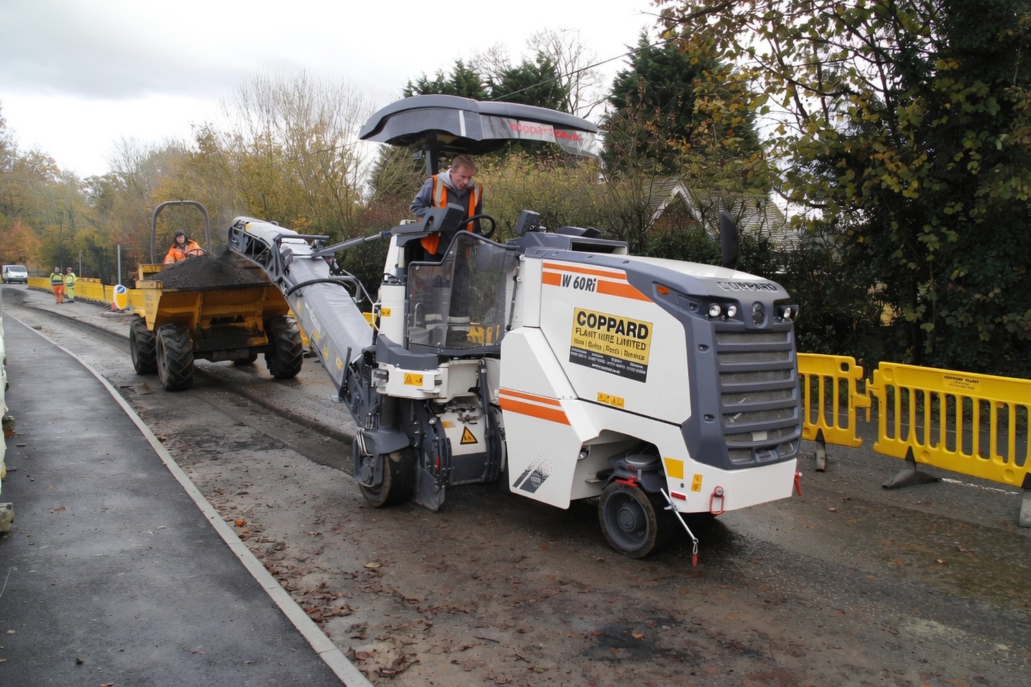 Asphalt milling machine planing the existing surface ahead of resurfacing