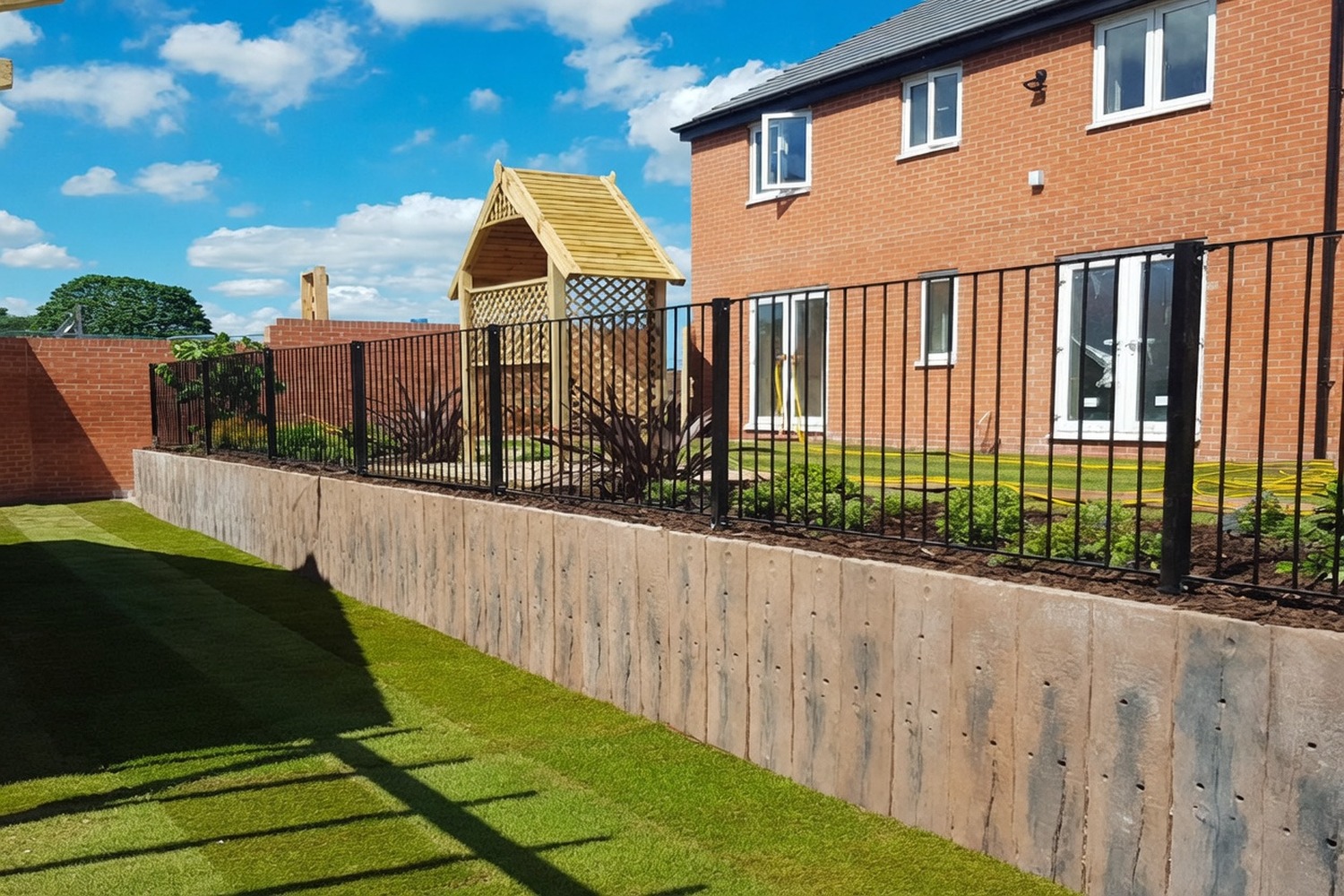 Concrete retaining wall holding back a planted garden bank