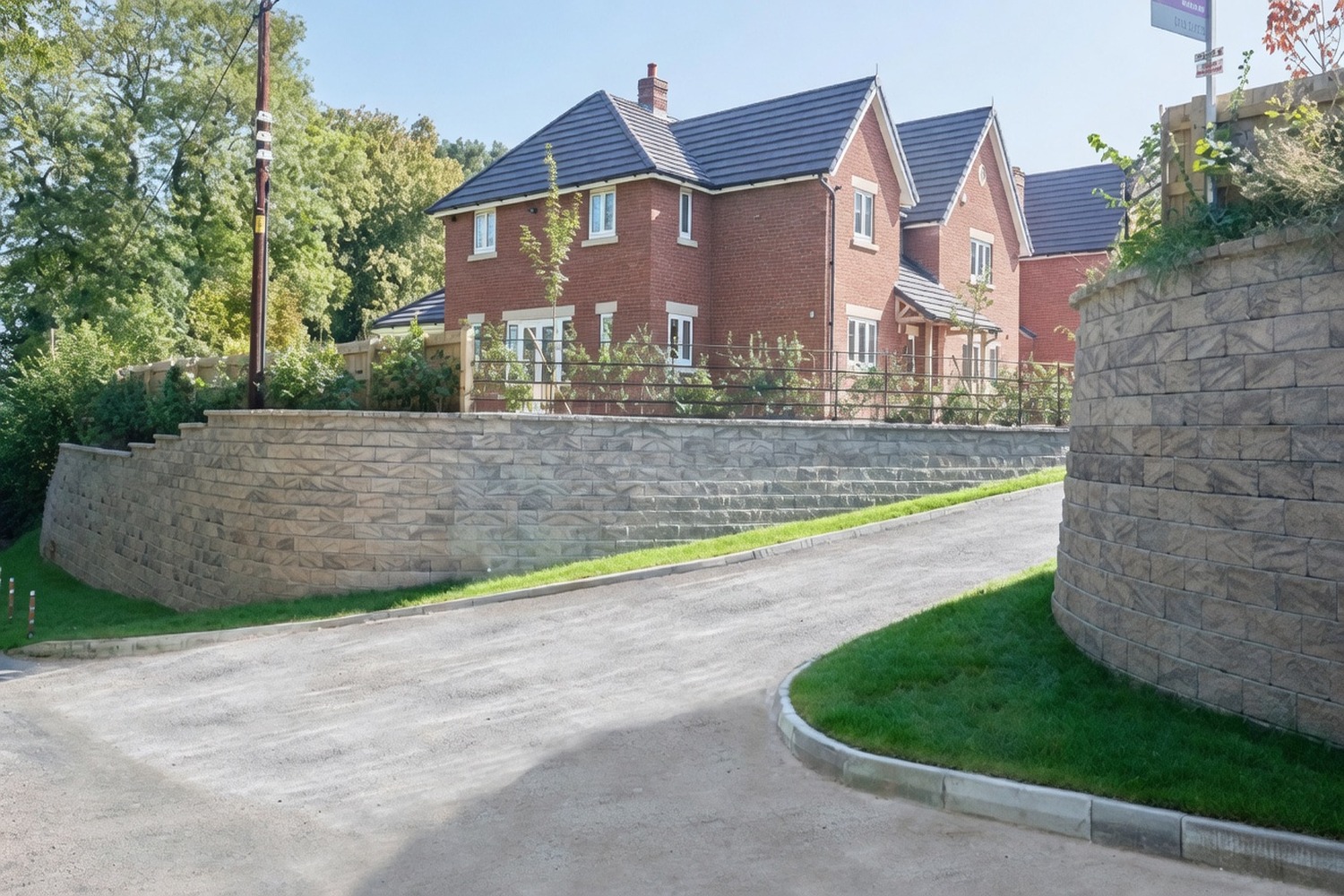 Driveway entrance with stone retaining wall and finished kerb edging