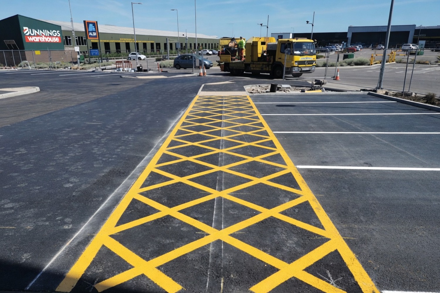 Yellow access-grid hatching on a retail car-park frontage