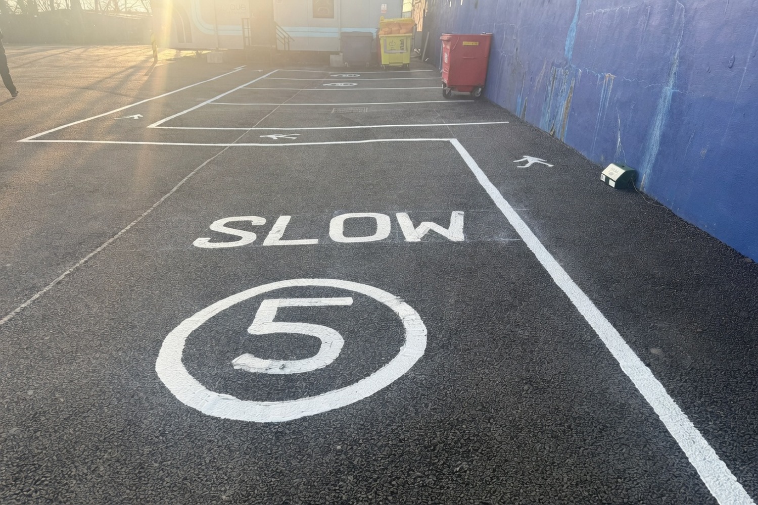 SLOW lettering with a 5-mph circle painted on a private road